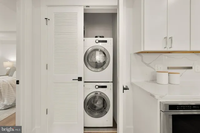 a utility room with sink dryer and washer