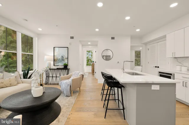 a kitchen with stainless steel appliances kitchen island granite countertop a table and chairs