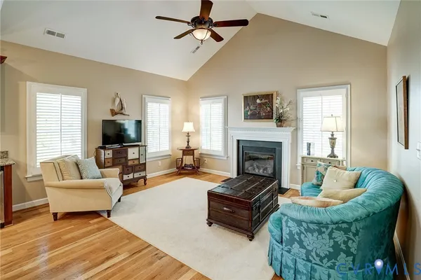 a living room with furniture fireplace and window