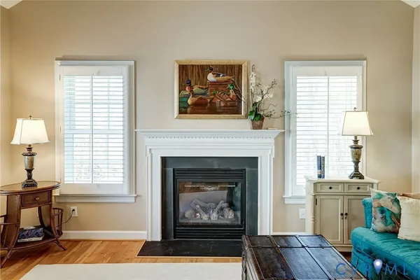 a living room with furniture a window and a fireplace