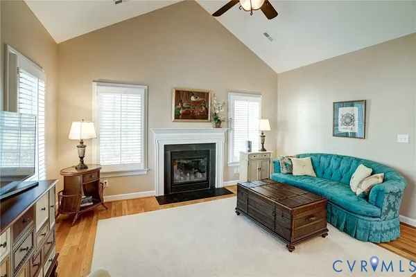 a living room with furniture fireplace and a window