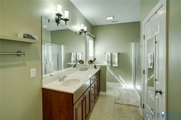 a bathroom with a sink vanity and a mirror