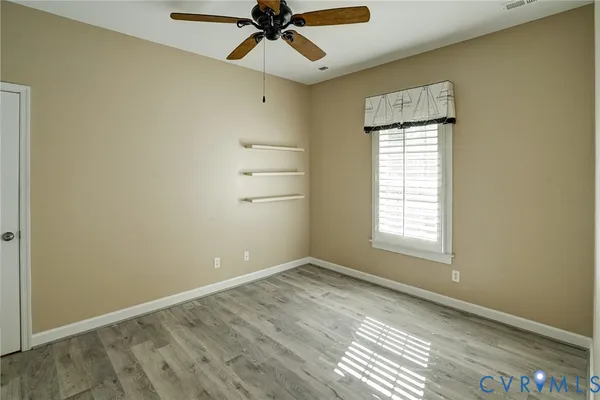 wooden floor in an empty room with a window