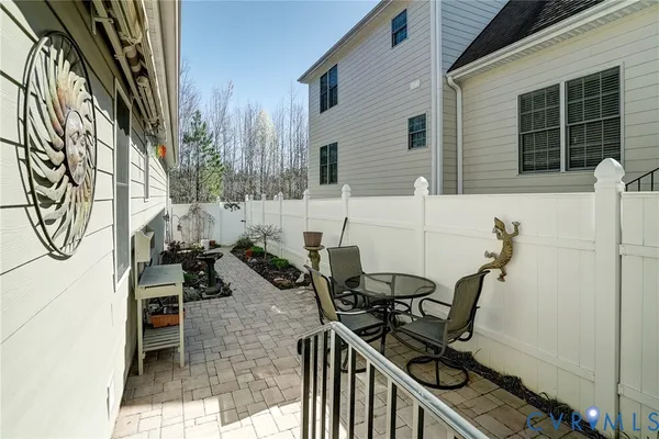 a view of a chairs and table in the balcony