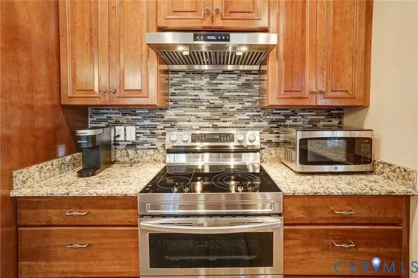 a stove top oven sitting inside of a kitchen