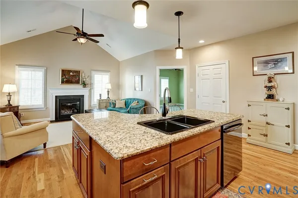 a kitchen with granite countertop a sink a counter top space appliances and cabinets