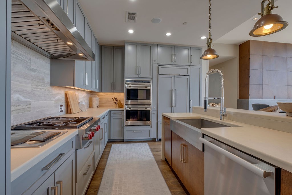 1212 Laurel Street, Unit 2303 Nashville, TN 37203 - Photo 11 of 31 a kitchen with a sink stove and cabinets