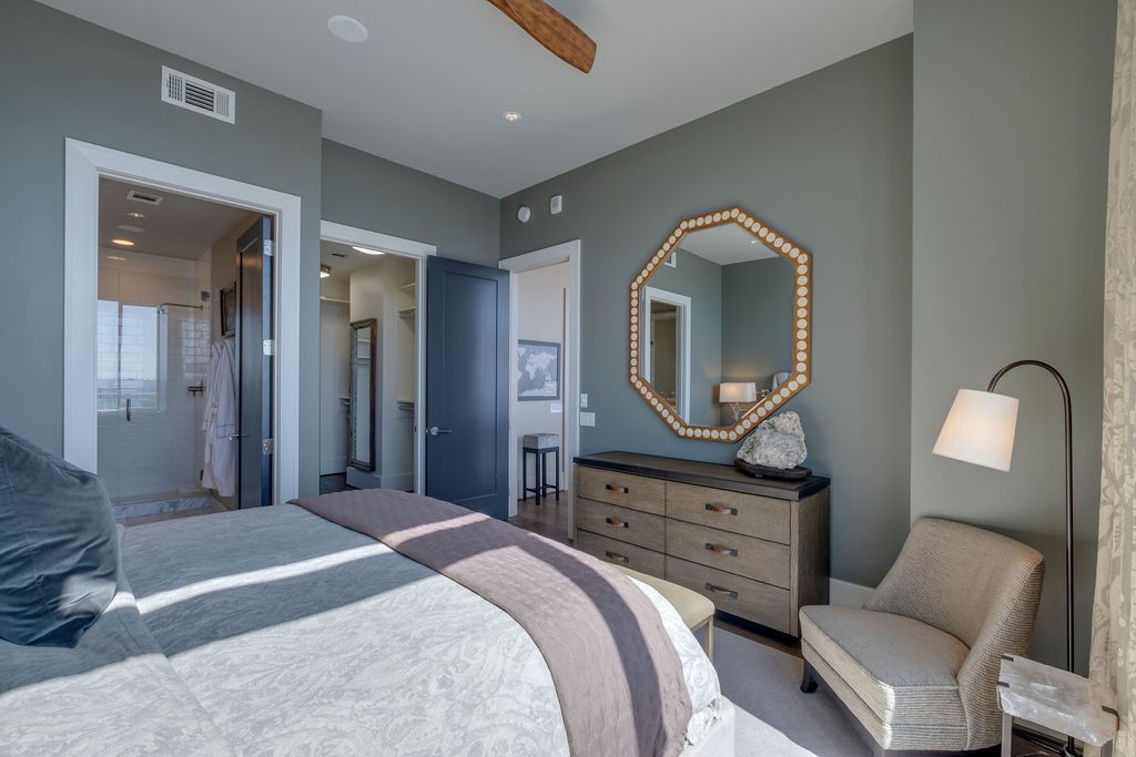 1212 Laurel Street, Unit 2303 Nashville, TN 37203 - Photo 22 of 31 a bedroom with a bed and a mirror on dresser