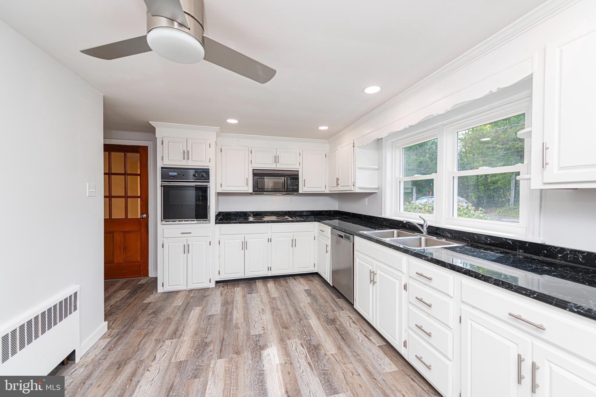 51 Keen Road Spring City, PA 19475 - Photo 15 of 32 a large kitchen with stainless steel appliances kitchen island granite countertop a stove and a sink