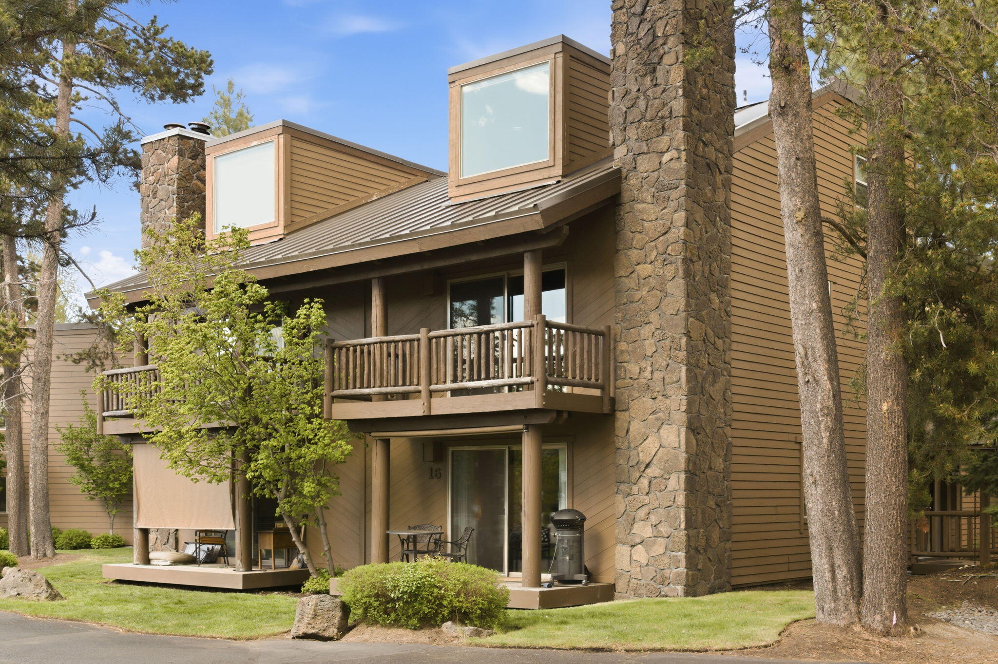 17654 Pinnacle Lane, Unit 16 Sunriver, OR 97707 - Photo 1 of 28 a front view of a house with garden