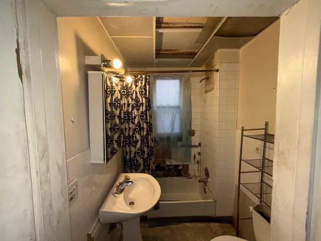 a bathroom with a sink toilet and shower