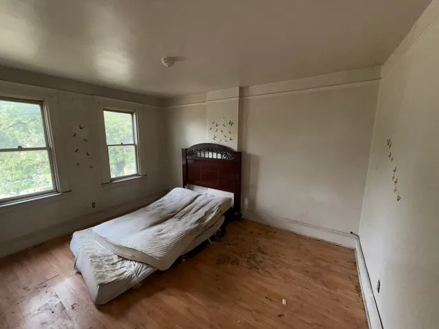 a bedroom with a bed and window