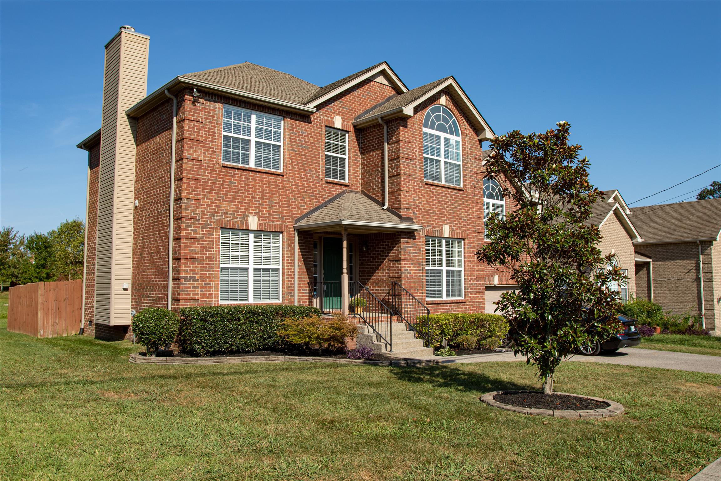 7064 Red Apple Road Antioch, TN 37013 - Photo 1 of 26 a front view of a house with garden