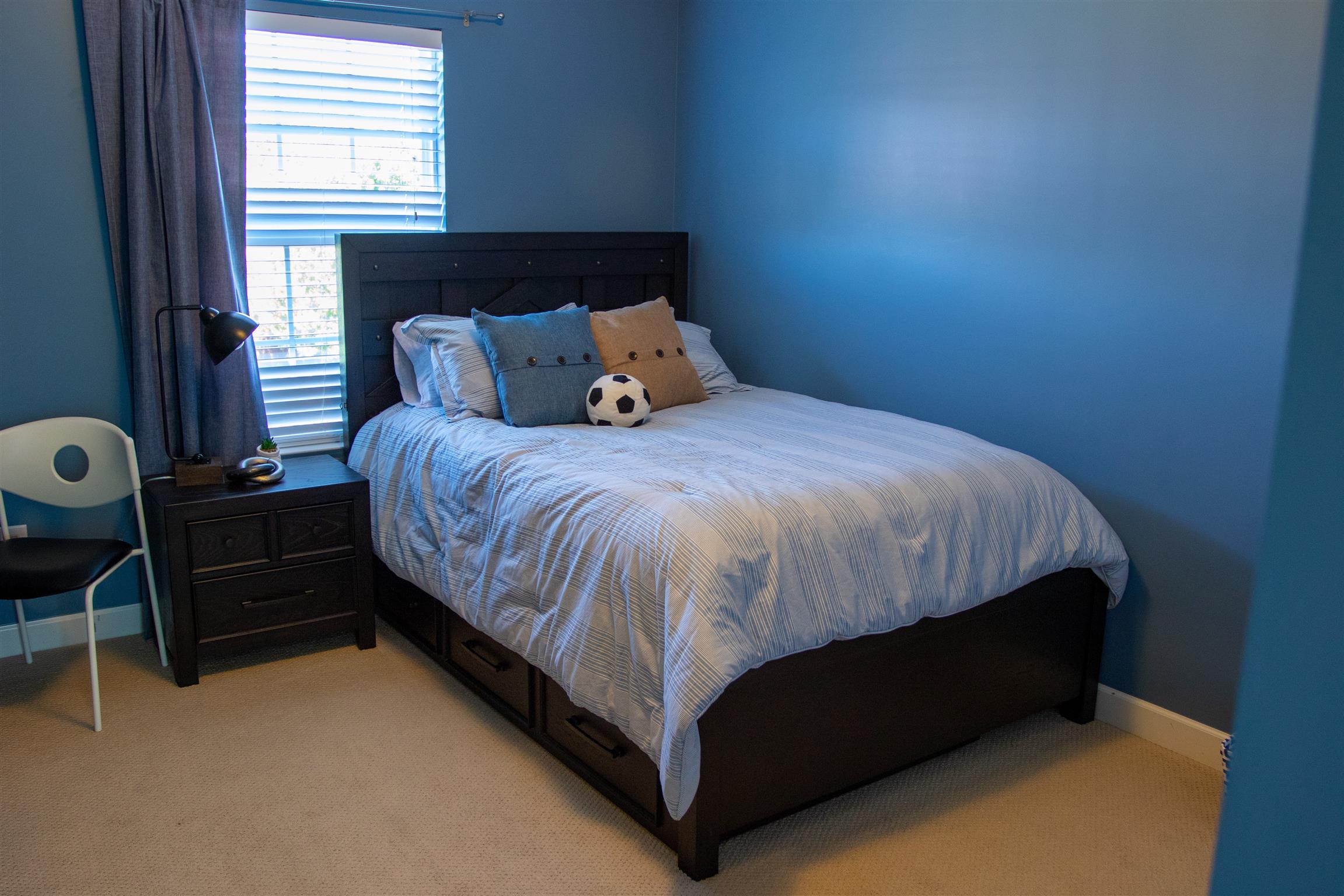 7064 Red Apple Road Antioch, TN 37013 - Photo 14 of 26 a bed sitting in a bedroom next to a window