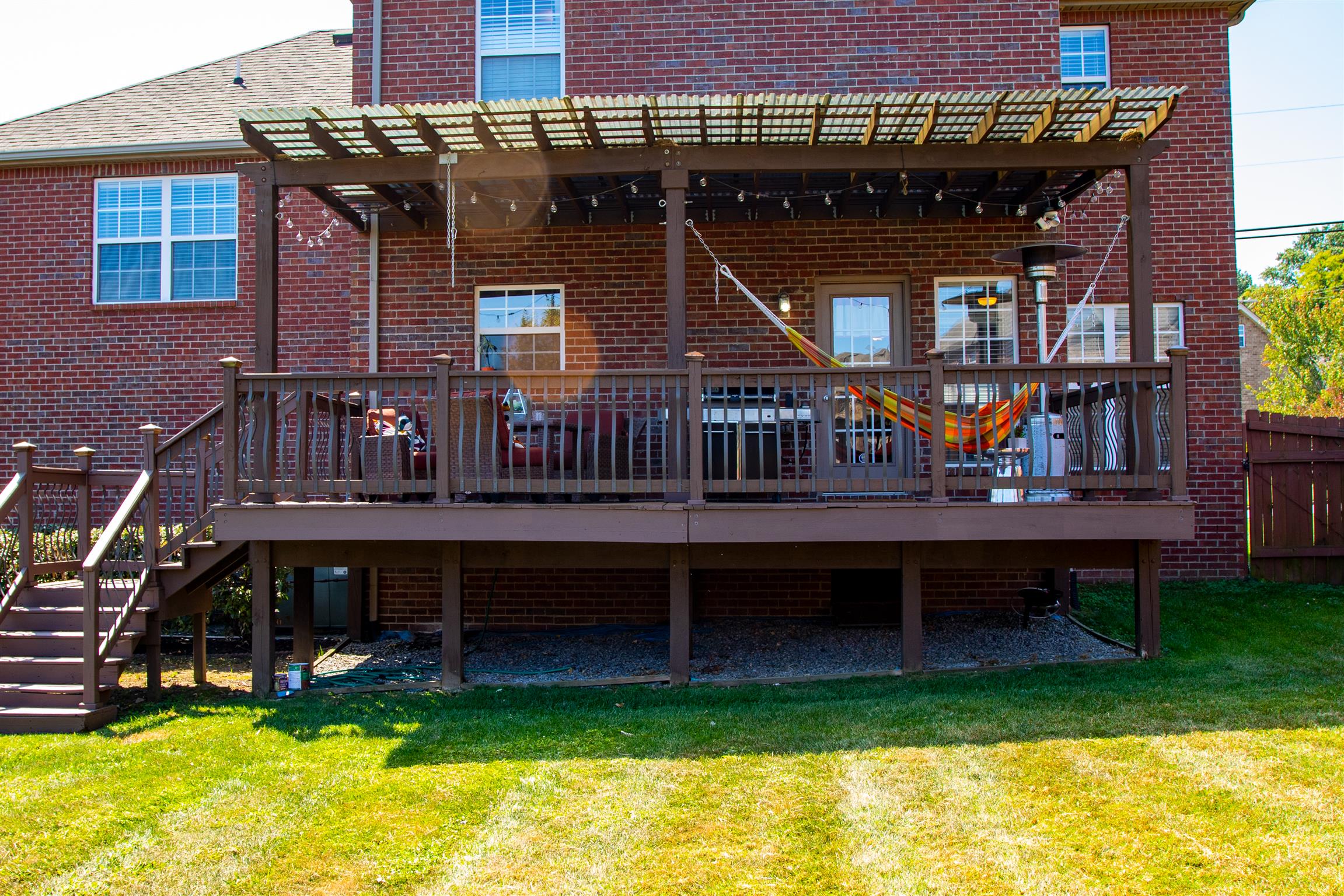 7064 Red Apple Road Antioch, TN 37013 - Photo 23 of 26 a view of a house with a wooden deck and a yard
