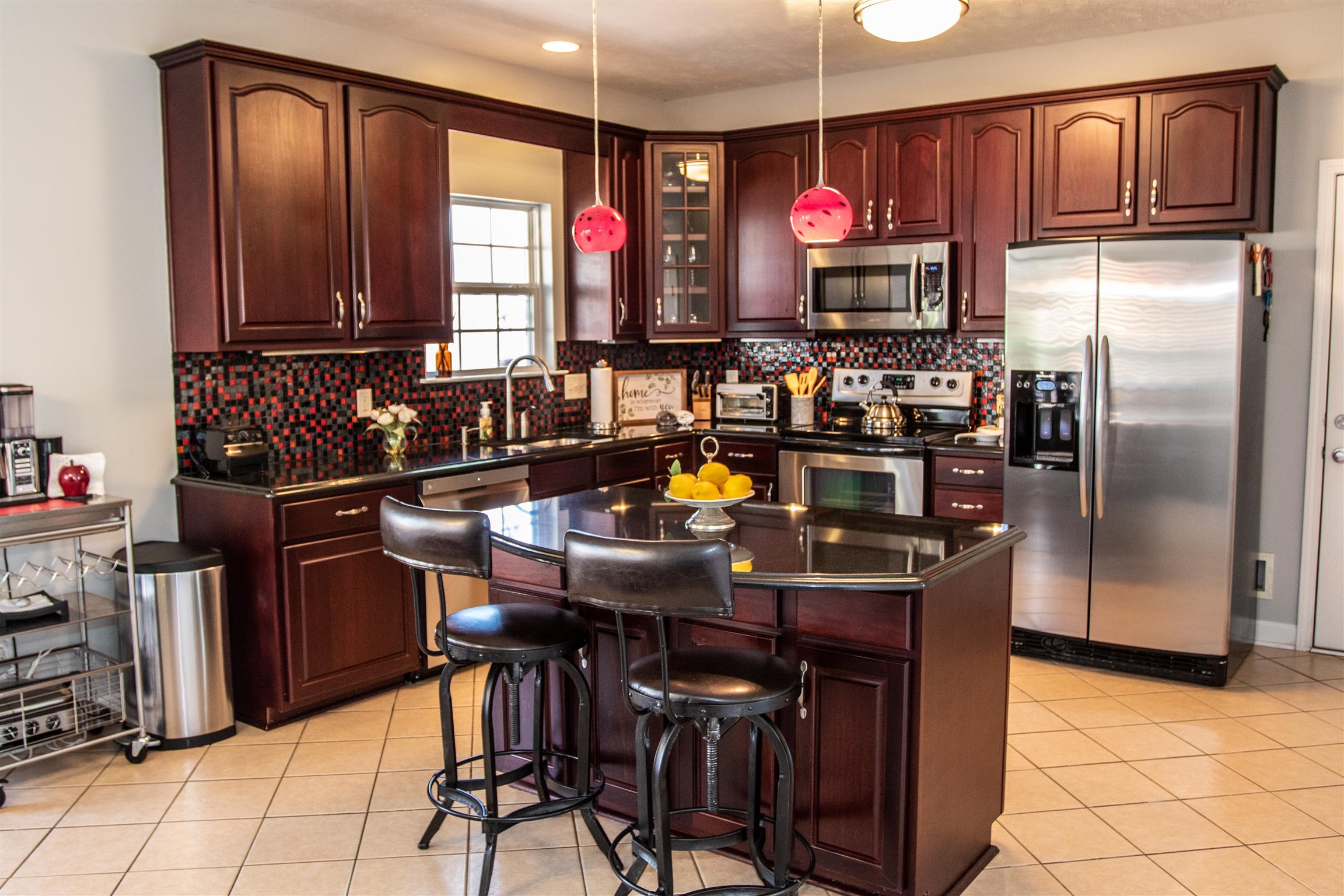 7064 Red Apple Road Antioch, TN 37013 - Photo 10 of 26 a kitchen with stainless steel appliances granite countertop a refrigerator and a stove top oven