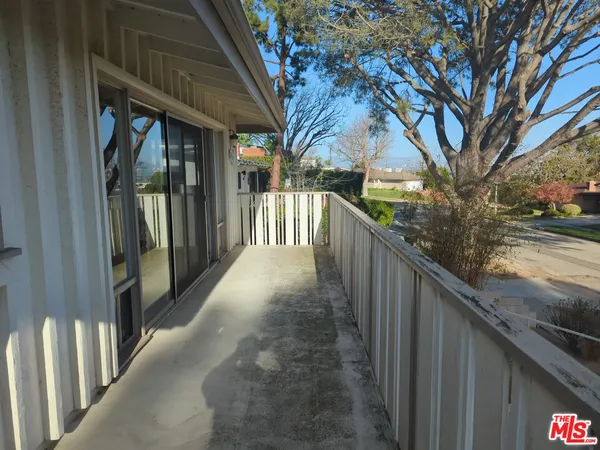 a view of a pathway of a house with a yard