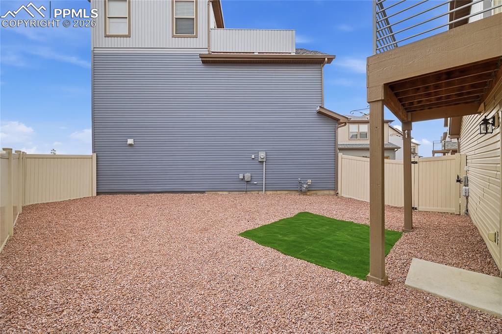 9414 Timberlake Loop Colorado Springs, CO 80927 - Photo 32 of 40 View of fenced backyard featuring a patio area with rocks and turf