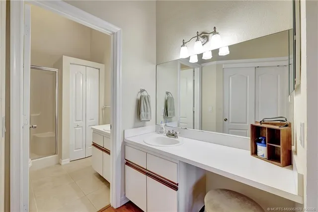 a bathroom with a sink a light fixture and a mirror