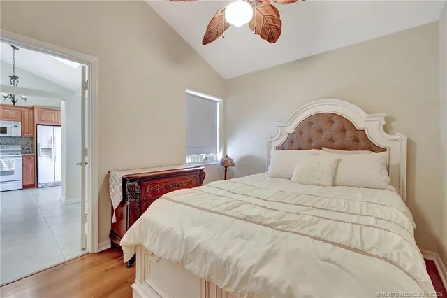 a bedroom with a bed and a painting on the wall