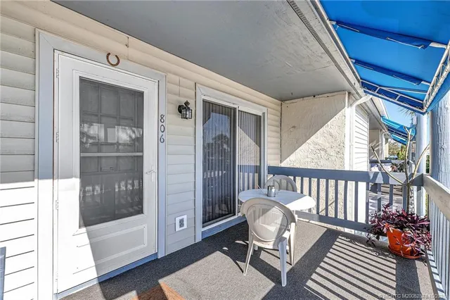 a view of porch with furniture and front door