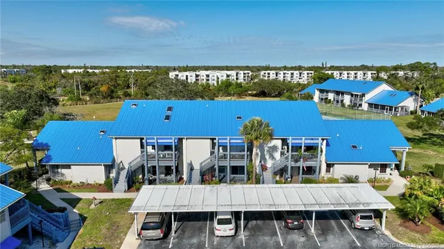 an aerial view of a house with swimming pool and outdoor seating