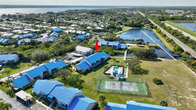 an aerial view of residential houses with outdoor space and swimming pool