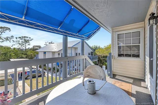 a view of a balcony with furniture