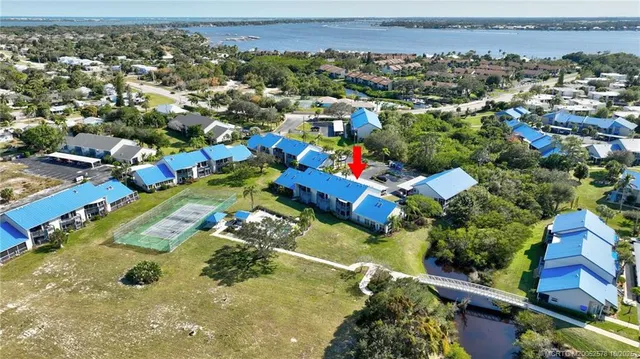 an aerial view of residential houses with outdoor space