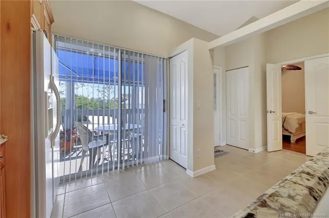 a bedroom with furniture and a large window