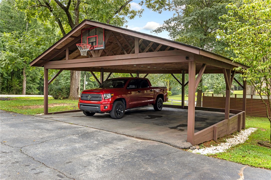 404 Davis Road Liberty, SC 29657 - Photo 38 of 39 A spacious carport offers covered parking and recreational fun with an integrated basketball hoop.