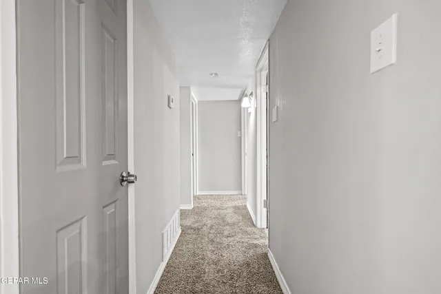 a view of a hallway with a white walls