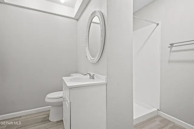 a bathroom with a toilet a sink and a mirror