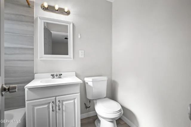 a bathroom with a sink toilet and mirror