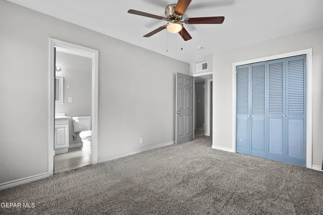 a view of an empty room and a bathroom