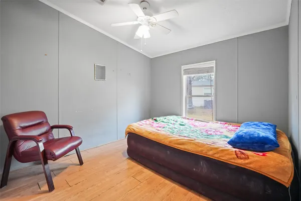 a spacious bedroom with a bed and a chandelier
