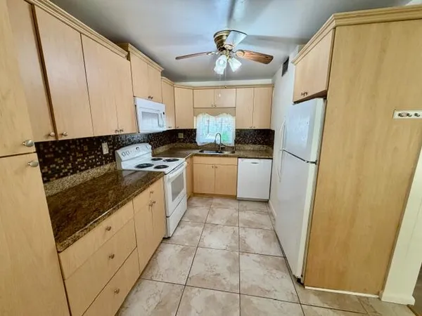a kitchen with a refrigerator a stove a sink and dishwasher