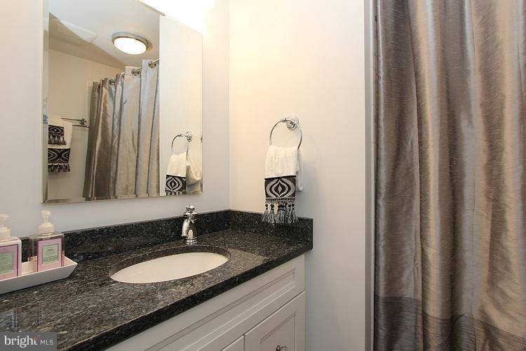 11327 Myrtle Lane Reston, VA 20191 - Photo 14 of 30 a bathroom with a granite countertop sink and a mirror