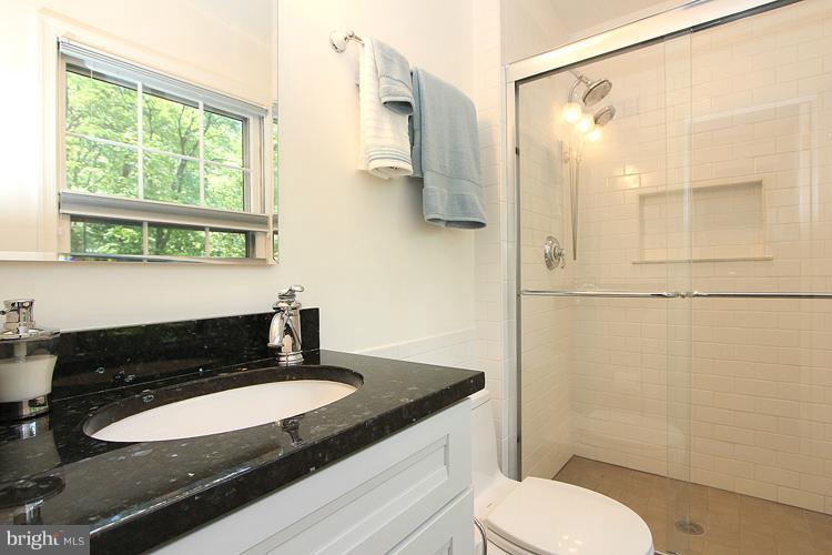 11327 Myrtle Lane Reston, VA 20191 - Photo 4 of 30 a bathroom with a granite countertop sink toilet and shower