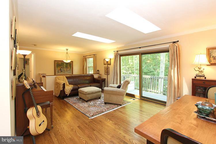 11327 Myrtle Lane Reston, VA 20191 - Photo 8 of 30 a living room with furniture and a floor to ceiling window