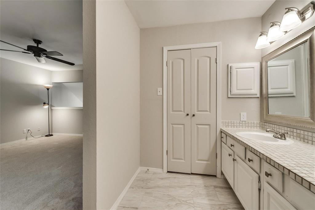 18240 Midway Road, Unit 302 Dallas, TX 75287 - Photo 27 of 33 a bathroom with a double vanity sink a mirror and a shower