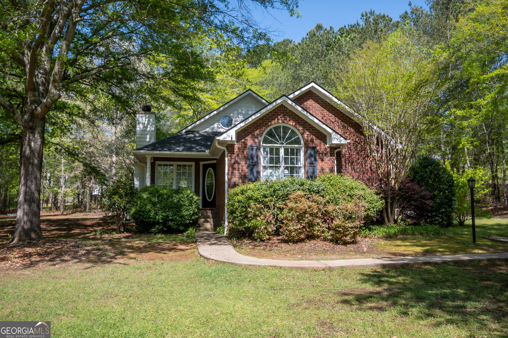 a front view of a house with a garden