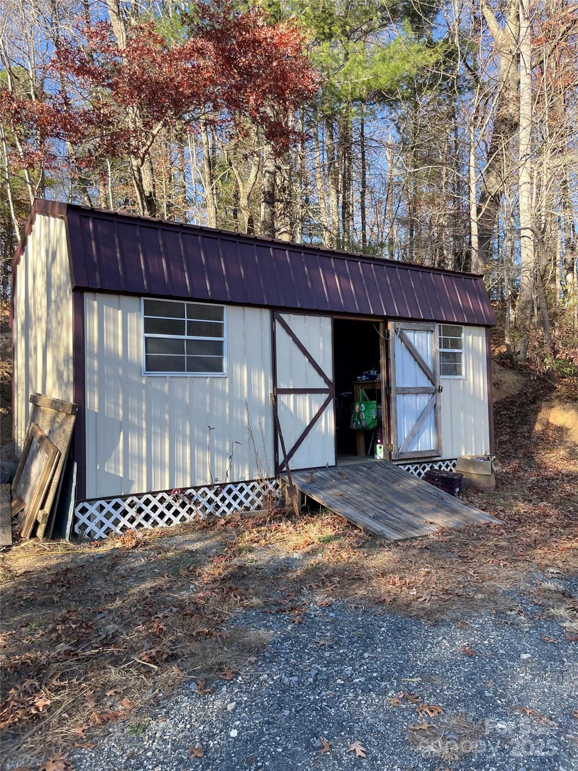 3265 Revere Road Marshall, NC 28753 - Photo 3 of 23 a view of a house with a small yard and wooden fence