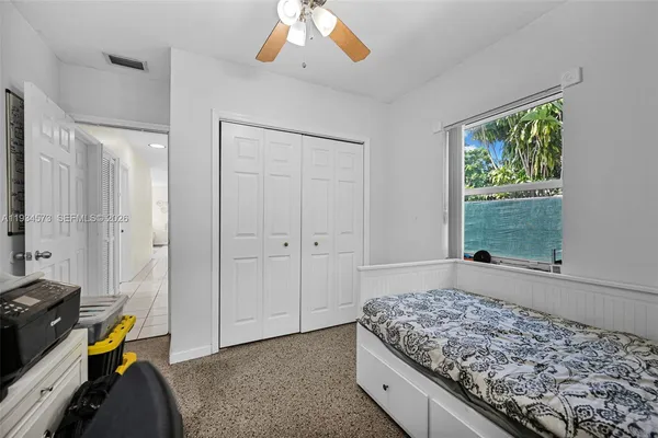 a living room with furniture a flat screen tv and a dining table