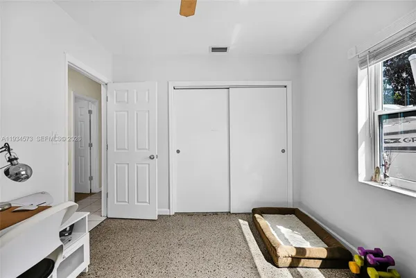 a kitchen with a refrigerator and a stove top oven