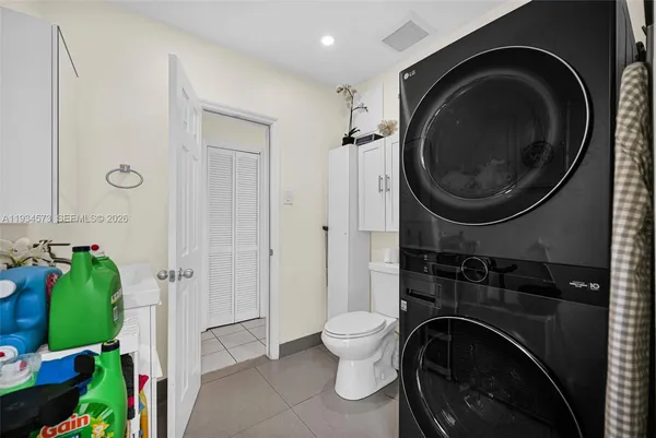 a kitchen with granite countertop a stove a sink and a microwave