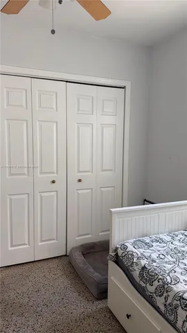 a bedroom with a bed and hallway