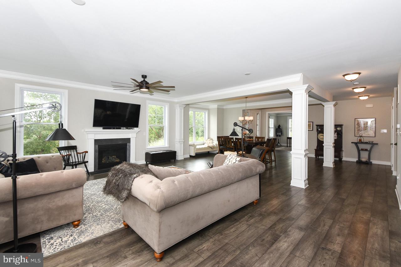 8 Elizabeth Lane Doylestown, PA 18901 - Photo 15 of 50 a living room with furniture a fireplace and a flat screen tv