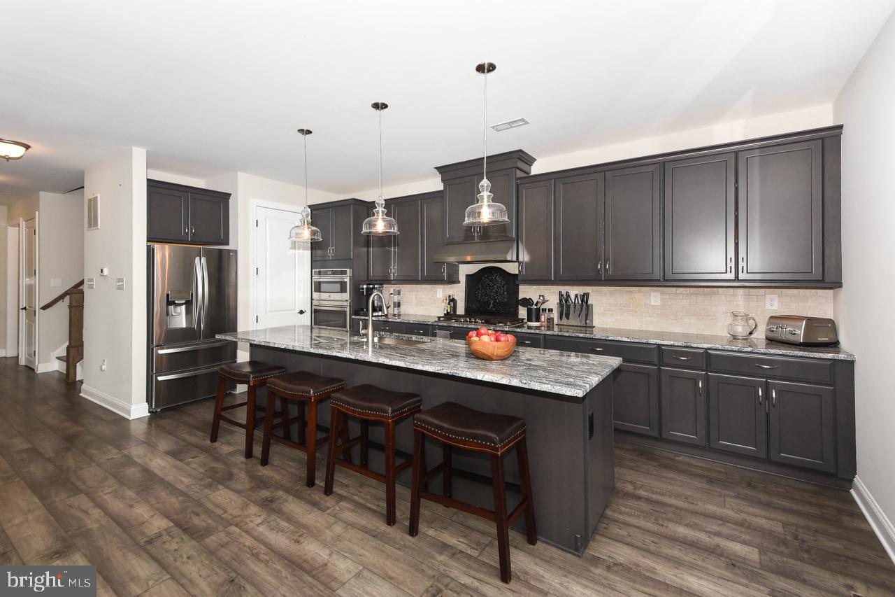 8 Elizabeth Lane Doylestown, PA 18901 - Photo 16 of 50 a kitchen with a sink a stove and chairs
