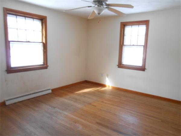 79 Fox Hill Road Springfield, MA 01118 - Photo 5 of 9 a view of an empty room with wooden floor and a window